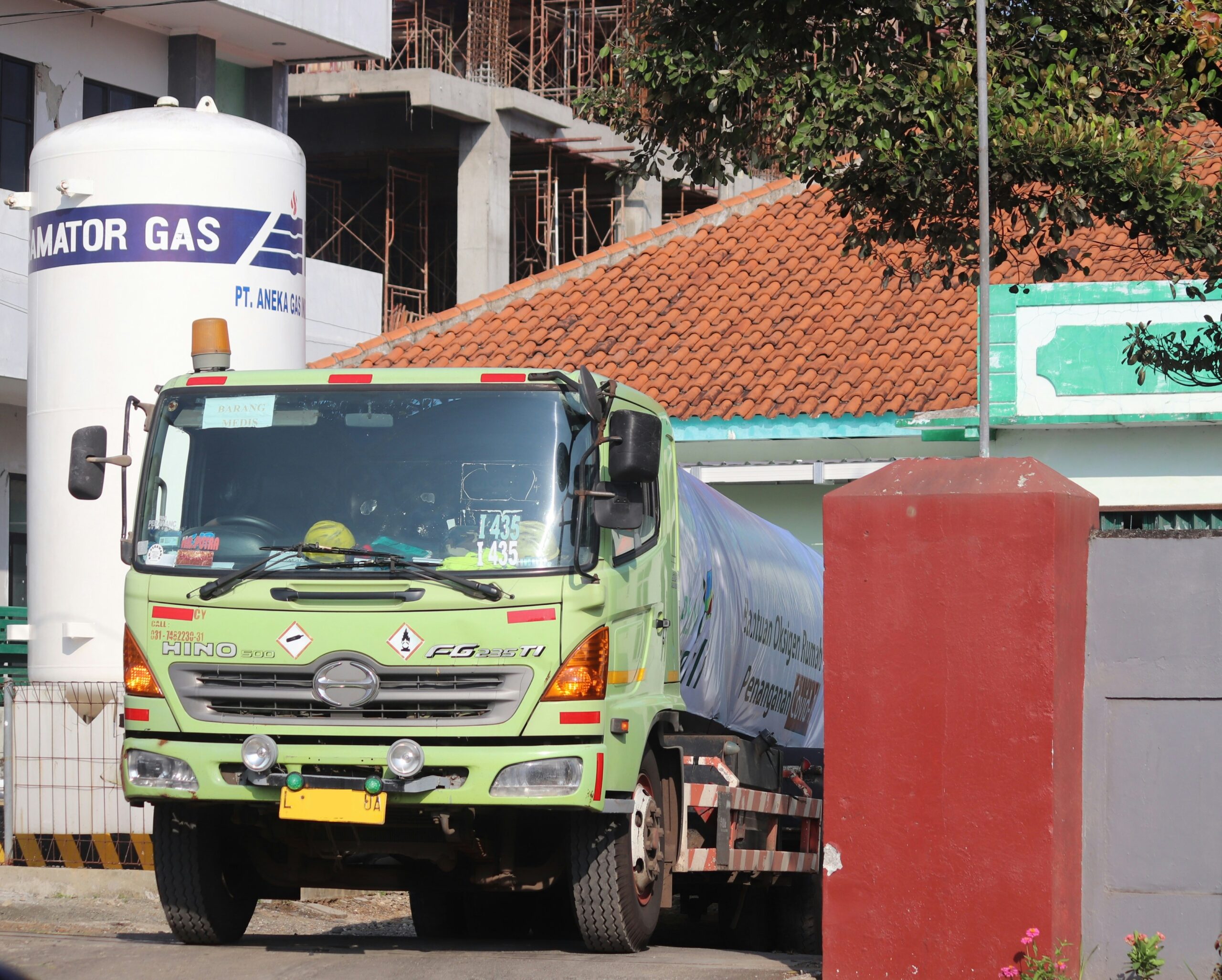 green and white truck on road during daytime